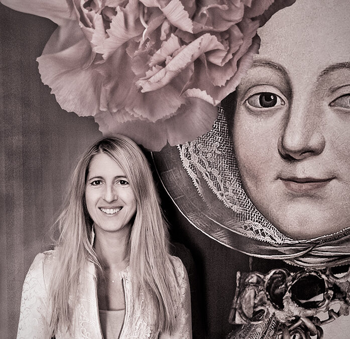Portrait of photographer Tamara Peel standing beside a historic painted female portrait