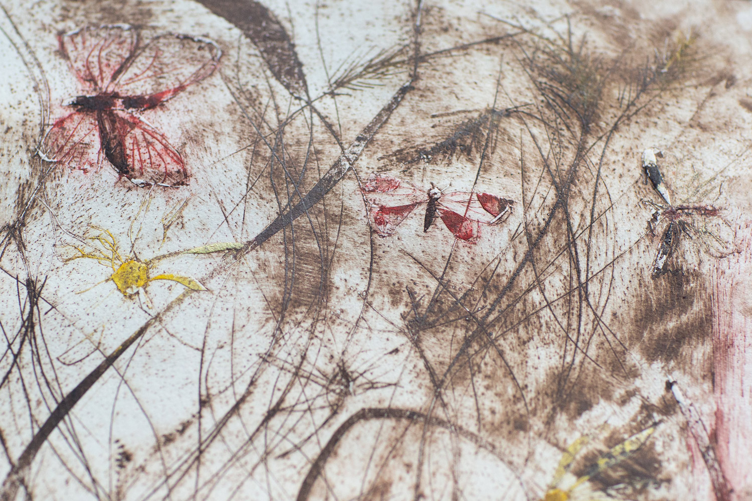 Alt text Close-up of an experimental etching printed with three different coloured inks, showing layered marks and overlapping lines.